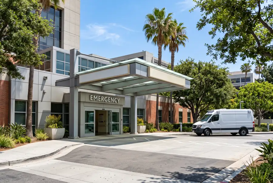 Hospital emergency entrance canopy on a bright day, illustrating when the ER is the right stop for dental pain