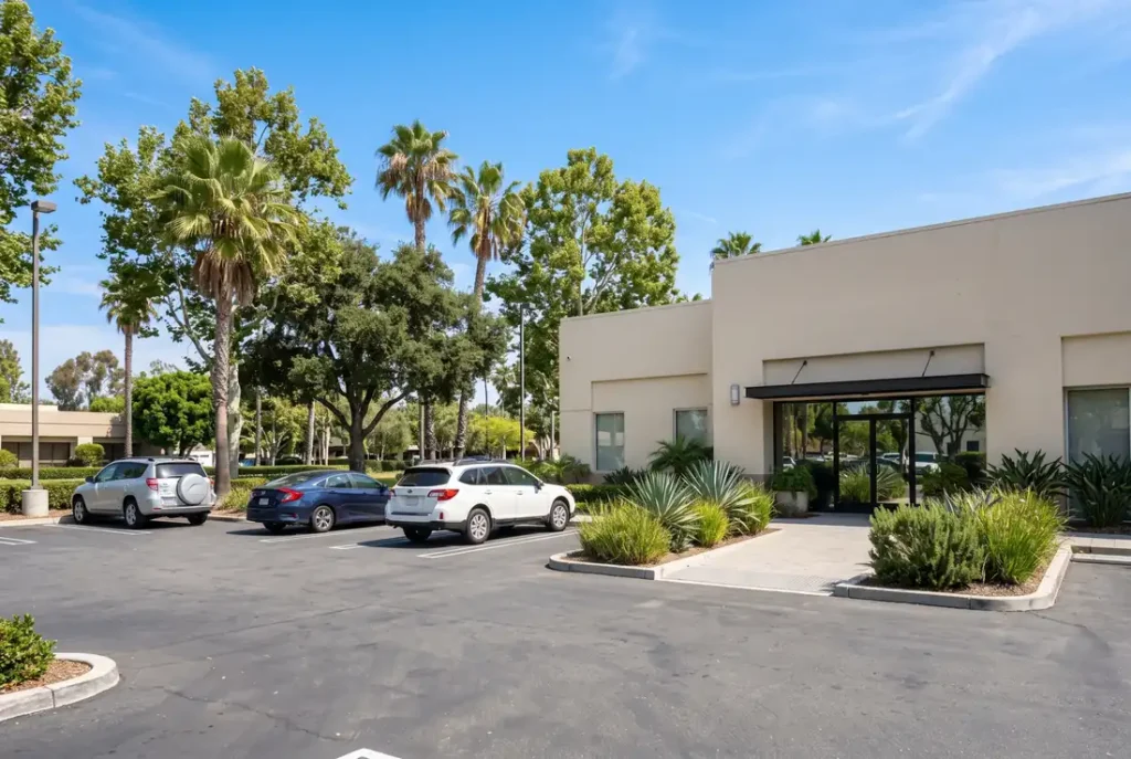 Sunny parking lot and entrance walkway outside a dental office in Reseda, California